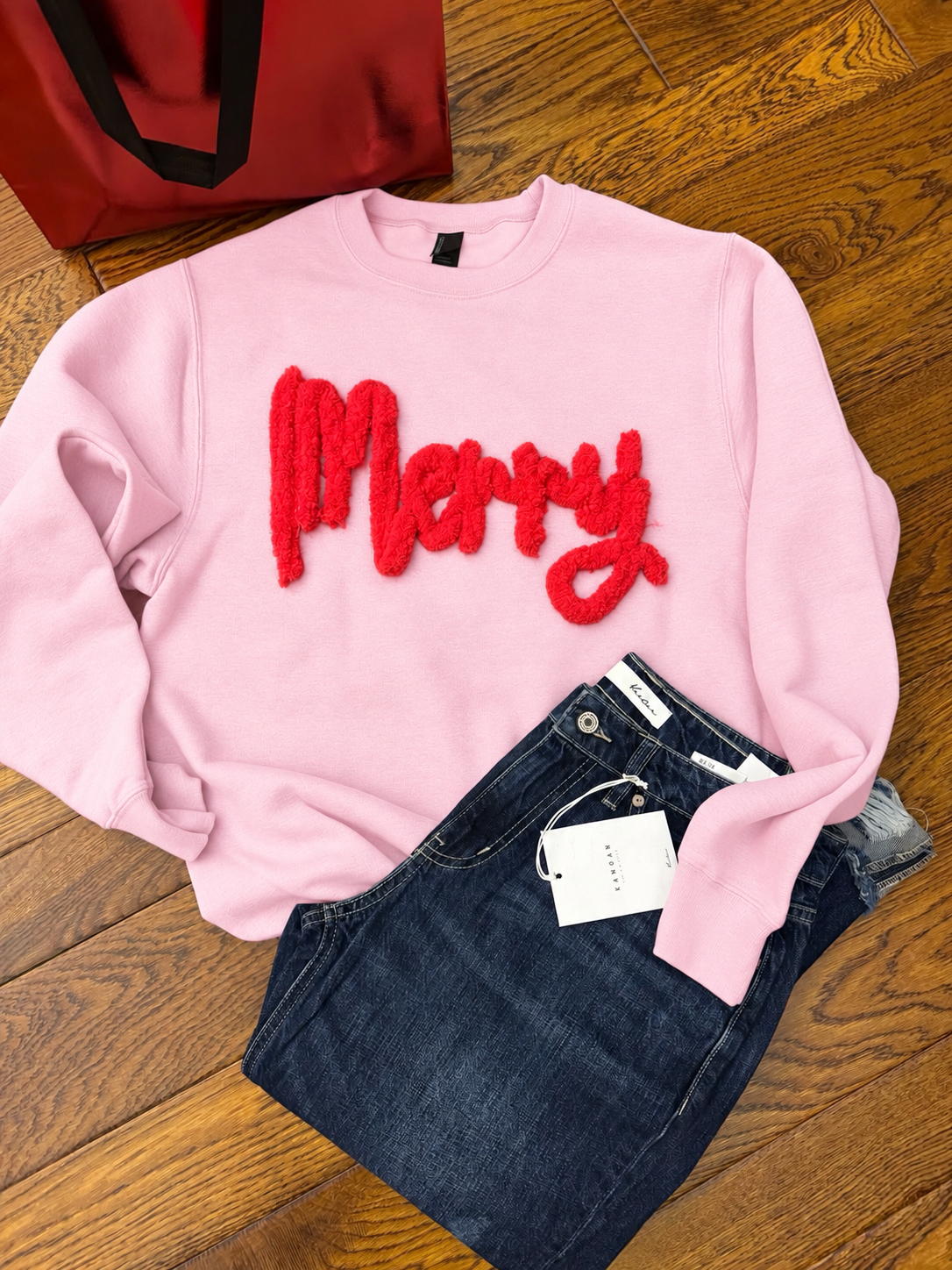 Light pink Gildan crewneck mockup with raised red Merry embroidery