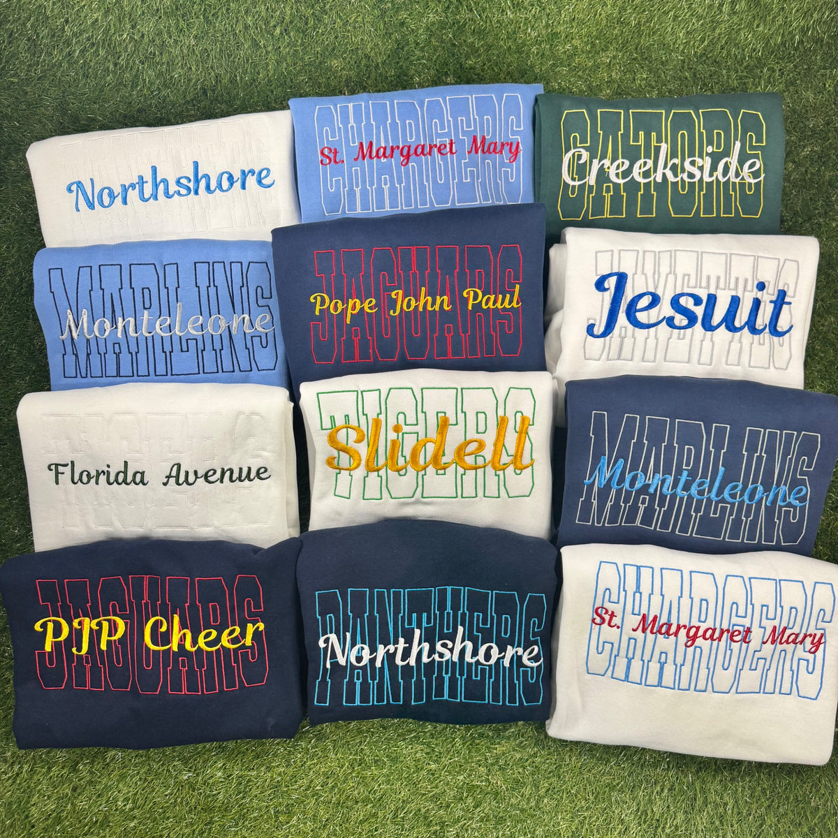 Custom embroidered mascot and school name sweatshirts in assorted school colors