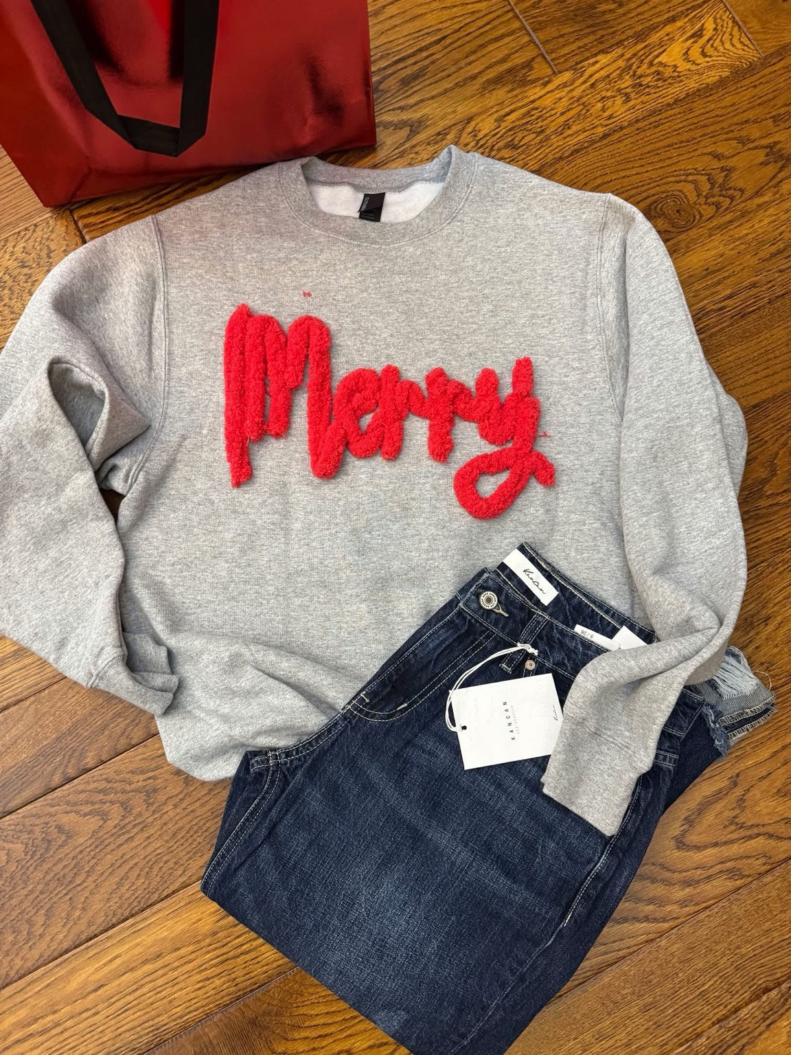 Gray crewneck fleece with raised red Merry lettering